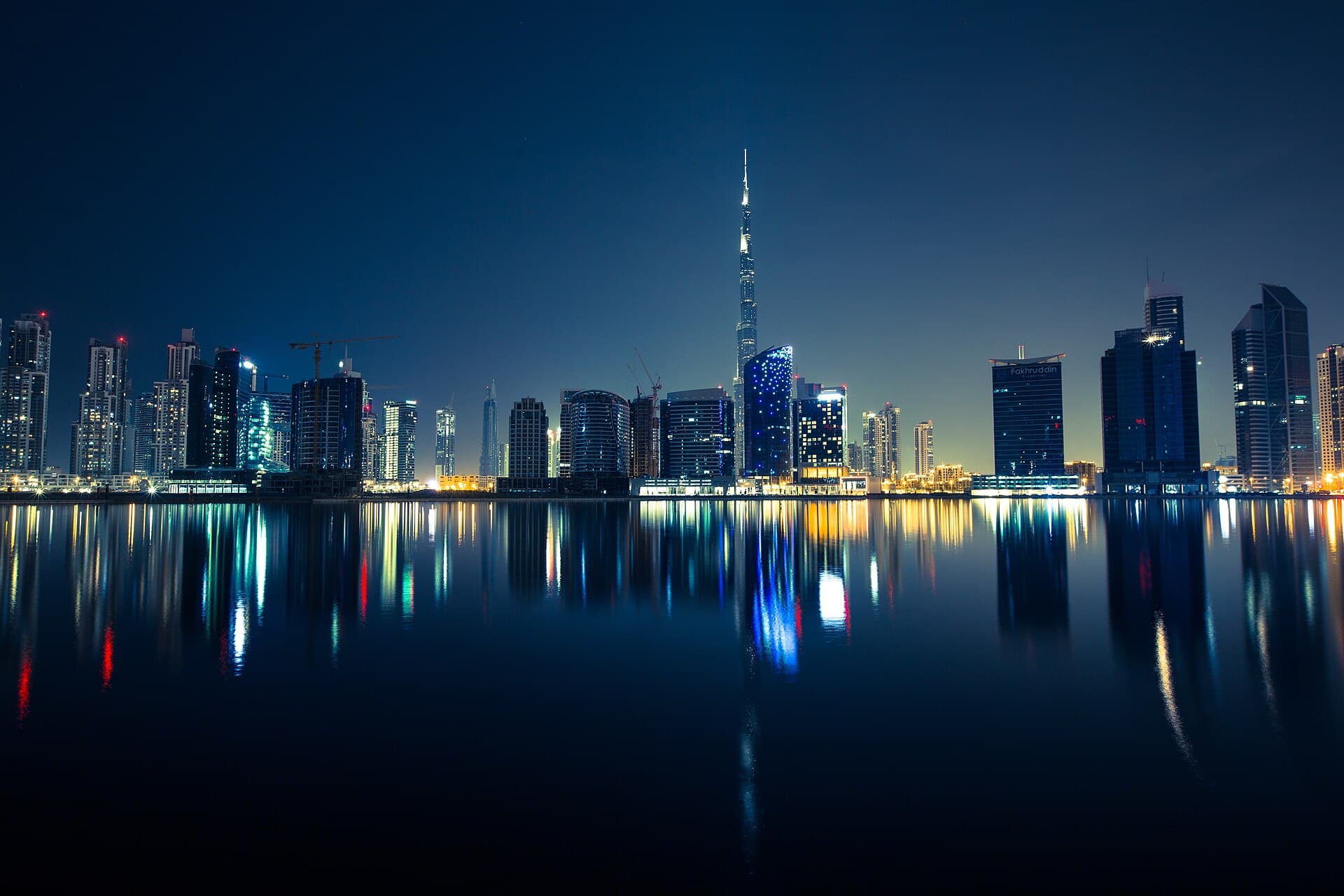 Dubai skyline reflected in the water at night