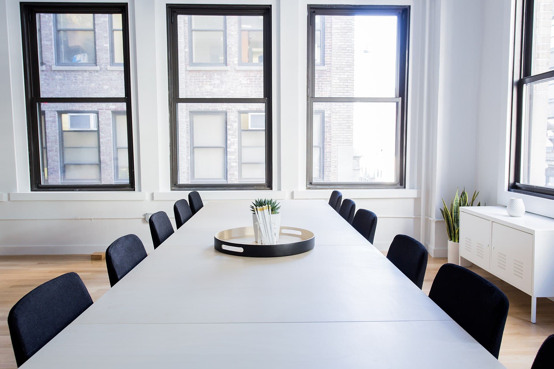 Minimalist meeting room with a long white table