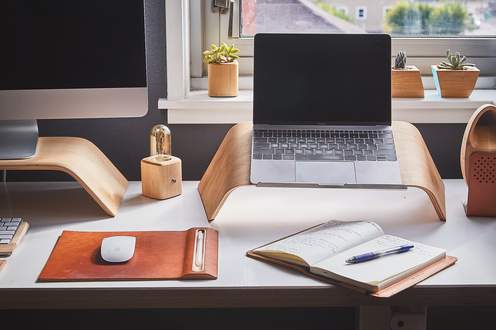 Tidy workspace with a laptop and an open notepad