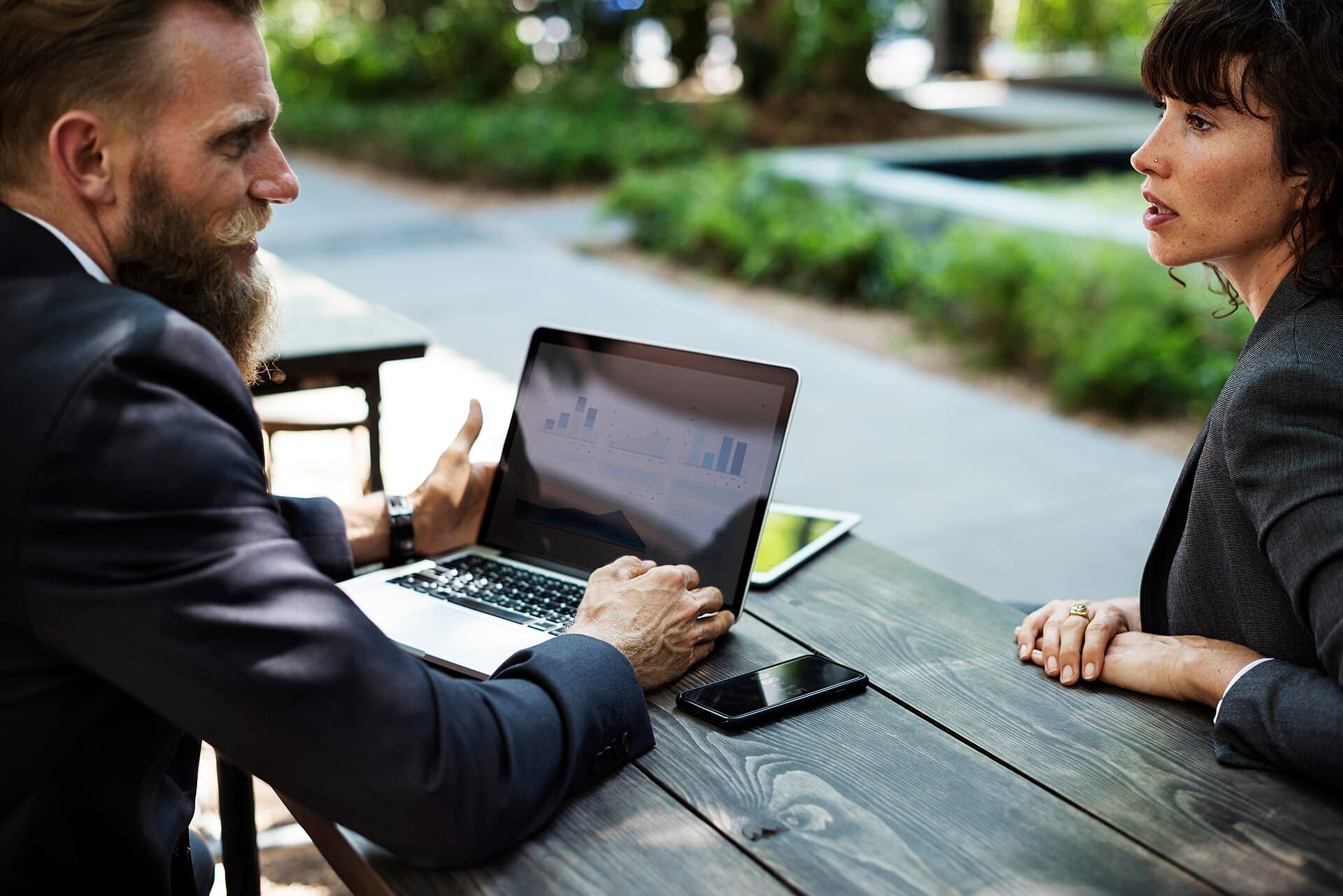 Two professionals discussing strategy over a laptop