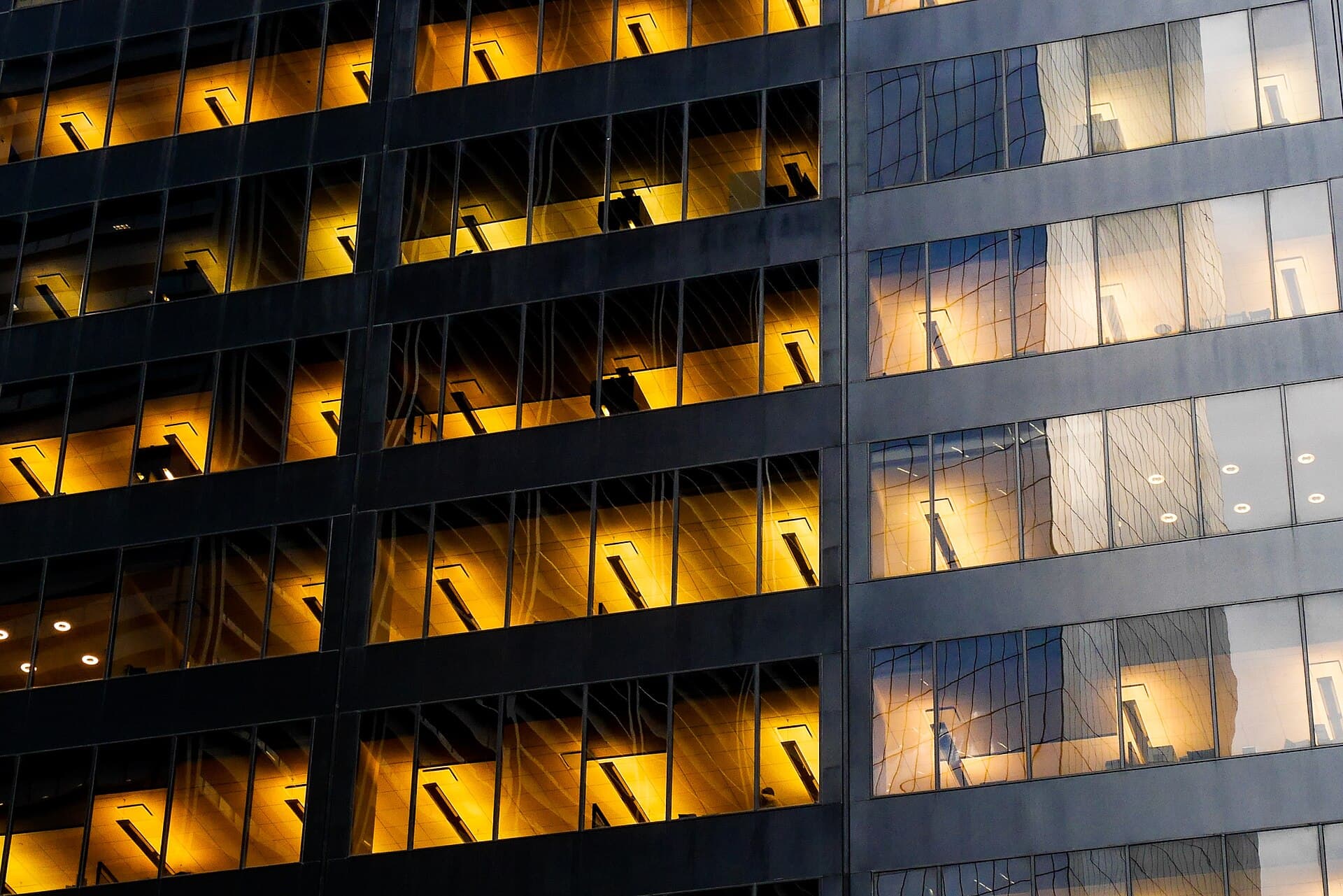Office building windows lit warmly at night