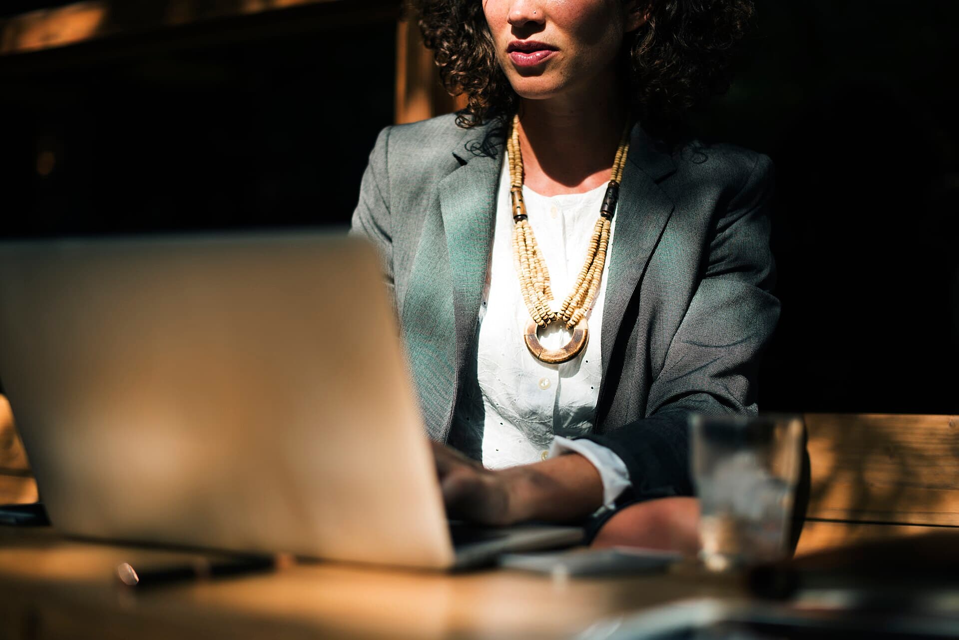Accountant working on a laptop in a dimly lit office